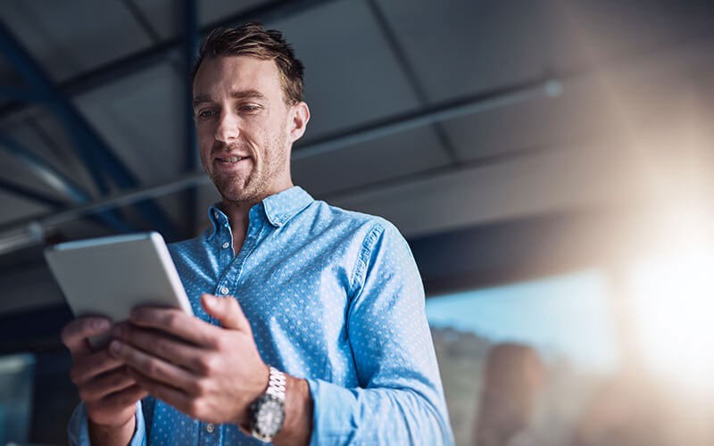 Work and data must be easily assessable from every device Businessman checks his teams projects off tablet computer between offices