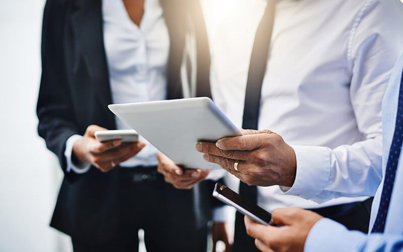 Bear the weight of powerful business applications Three business professionals check their email from their smart device