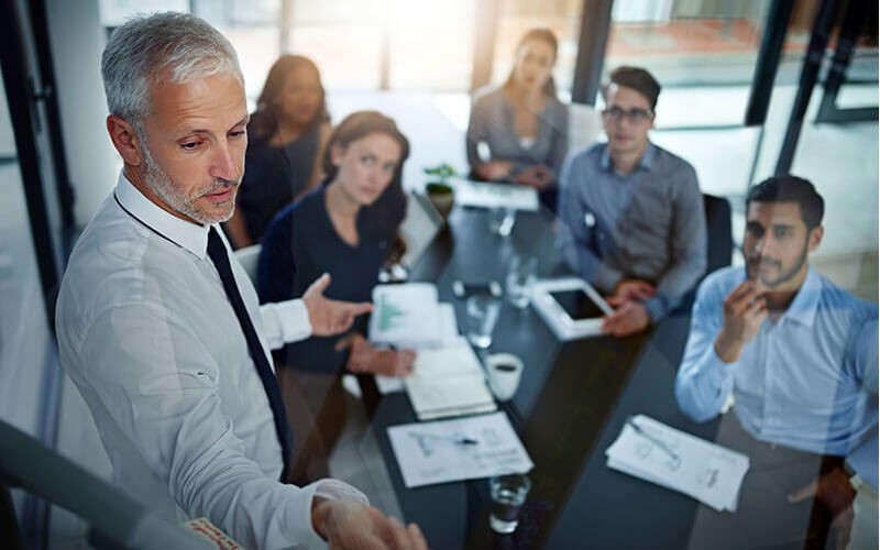 We will help you assess your existing technology and develop a road map to your goals Team discussing IT strategy road map in modern conference room