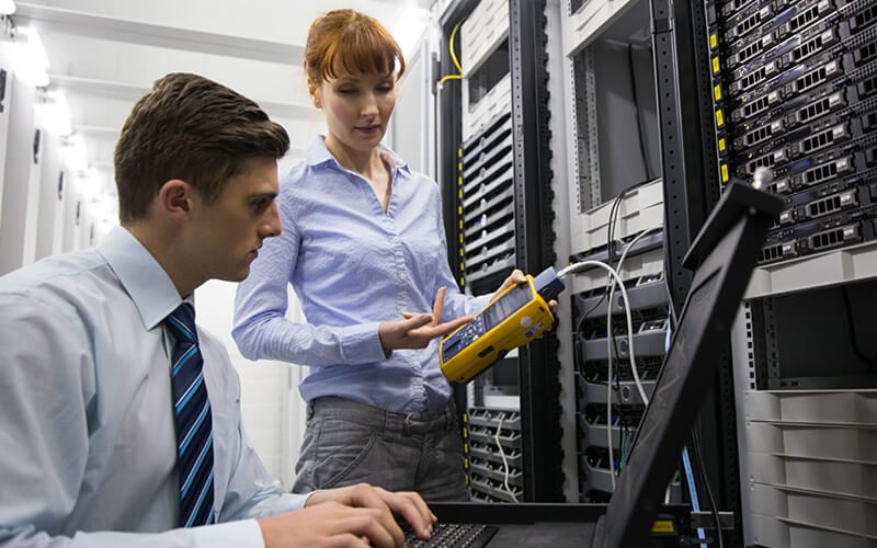Converged infrastructures are the perfect middle ground IT engineers assess data center issues with laptop computer