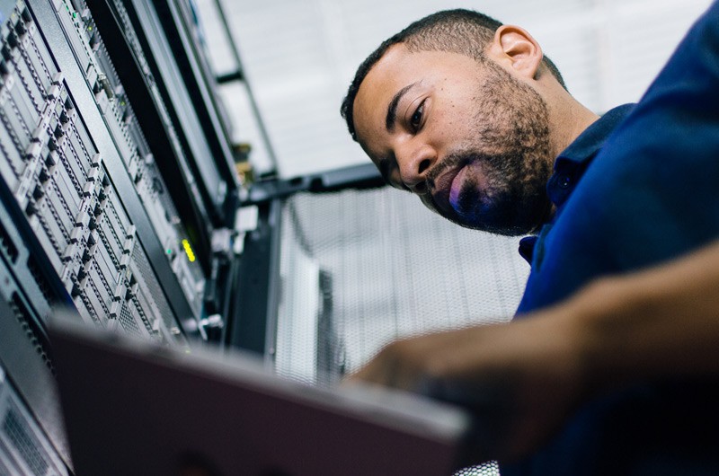 Hyperconverged solutions contain servers, storage, networking and software in one appliance IT network administrator reviewing business data from hyperconverged virtual machine in data center