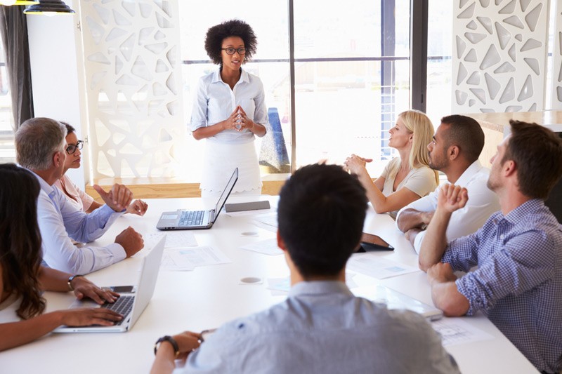 Address issues before they occur. African american business woman addressing conference room of people.