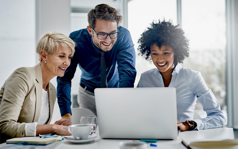 employees looking on laptop
