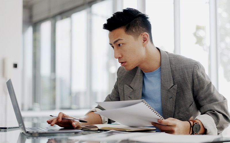 man taking notes on paper