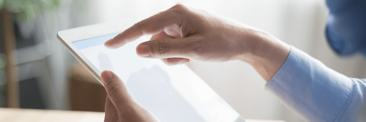 Close up of hand using touch screen on tablet