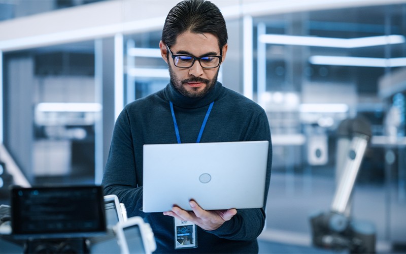 Give IT the visibility they need Male employee holding laptop