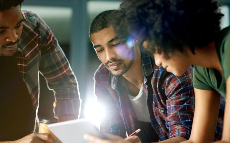 Securing cloud-connected networks Team collaborating in front of tablet