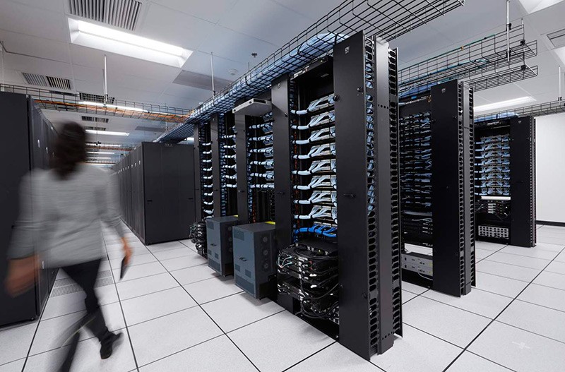 Woman Walking in a Large Data Center Woman Walking in a Large Data Center