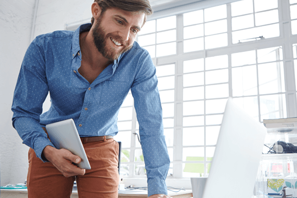 Man using Apple iPad and MacBook