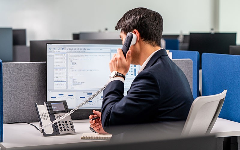 Business man using Polycom phone