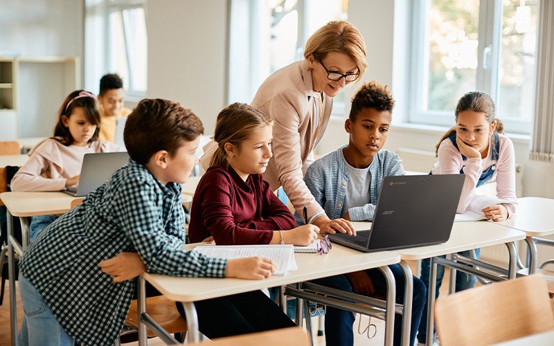 Classmates sharing a Chromebook