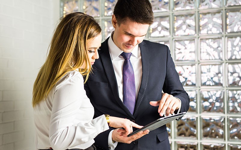 Two colleagues looking at an iPad