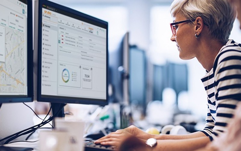 Woman sat at desk with computer.