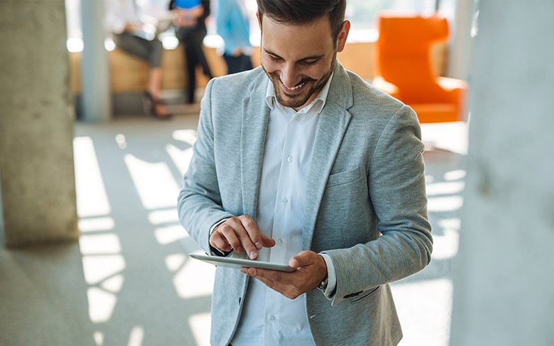 Man smiling using a tablet