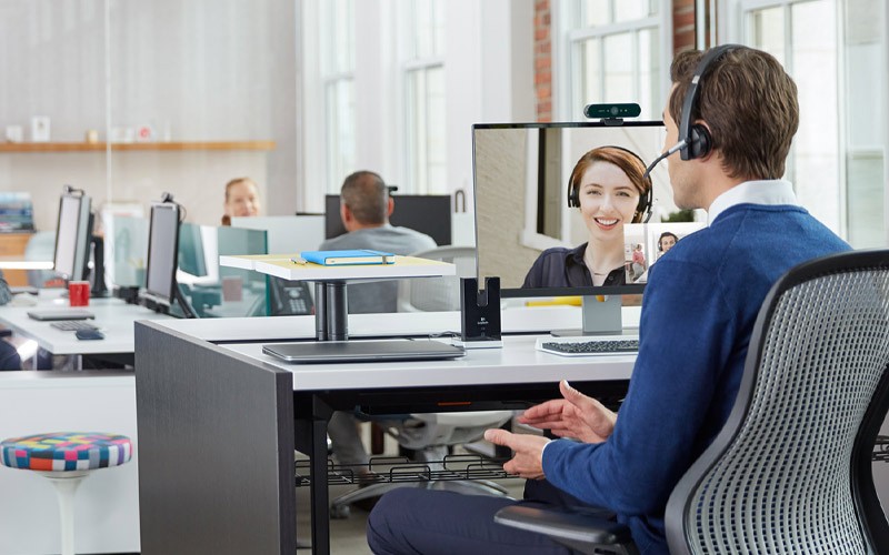 Man using Logitech solutions for a conference call
