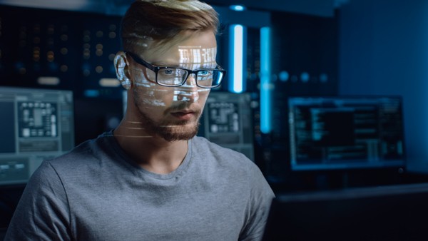 Protecting businesses against weaponised attachments Male concentrating on device to protect business security
