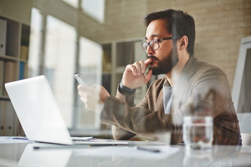 protect against zero day attacks Man using multiple devices