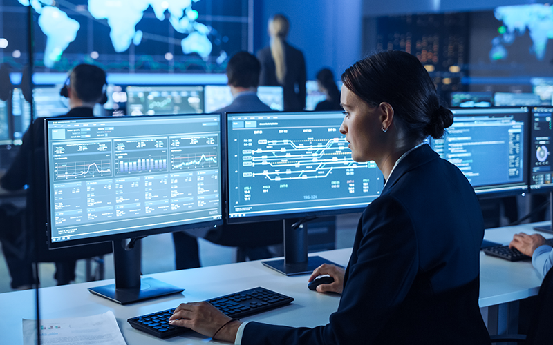 A woman working with code at a computer