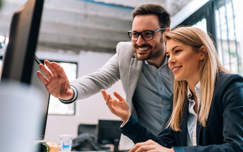 The Microsoft 365 plan for you Man assisting female coworker