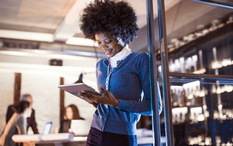 Engage customers and employees Small business owner on tablet device improving customer experience
