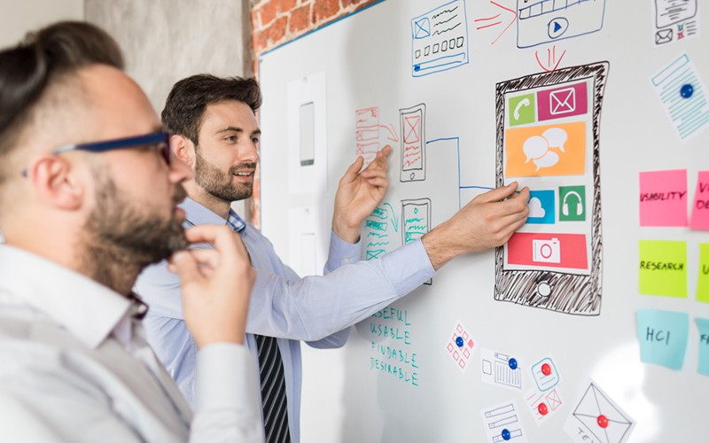Make quicker, smarter decisions UX designers brainstorm ideas with wireframes and sticky notes