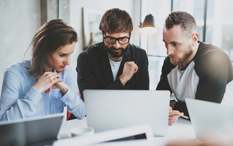 Leverage Azure Users collaborating at laptop