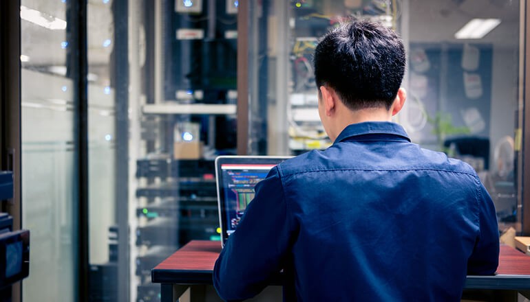 Offload your IT burden to our trusted team so you can focus on the road ahead Business professional using tablet computer
