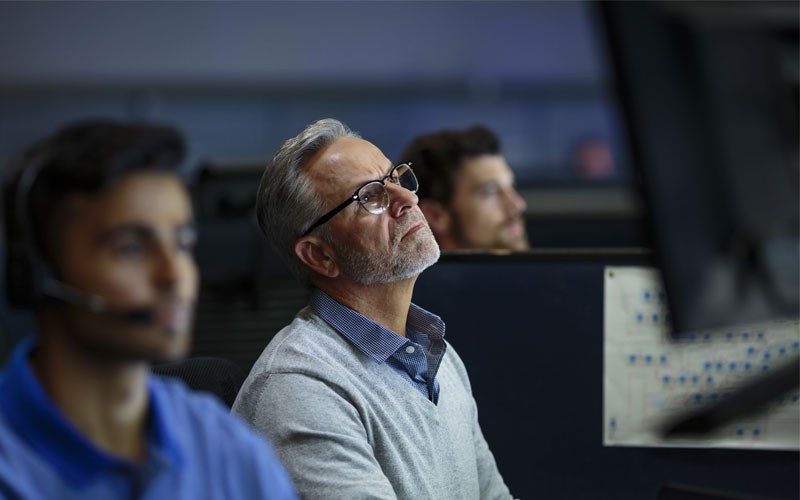 Data management and storage Man closely examining data on a computer screen