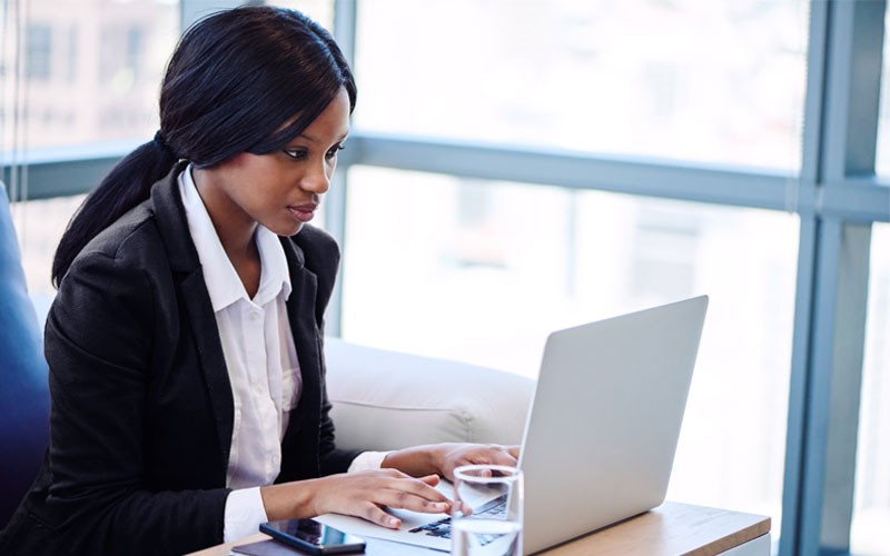 Revolutionize your industry with digital workforce Business woman typing on laptop