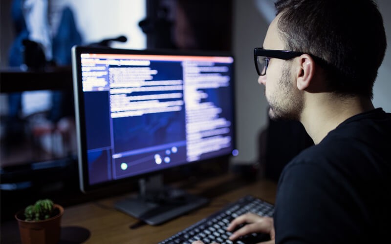 Infrastructure as code Programmer coding on desktop at night