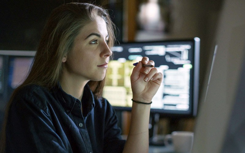 Your teams won’t need to completely rewrite existing code Programmer looks through code on desktop at night