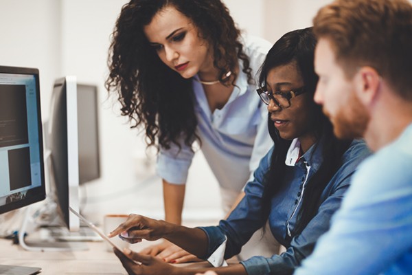 Equip your business for current and future challenges Team collaborating around desktop computer