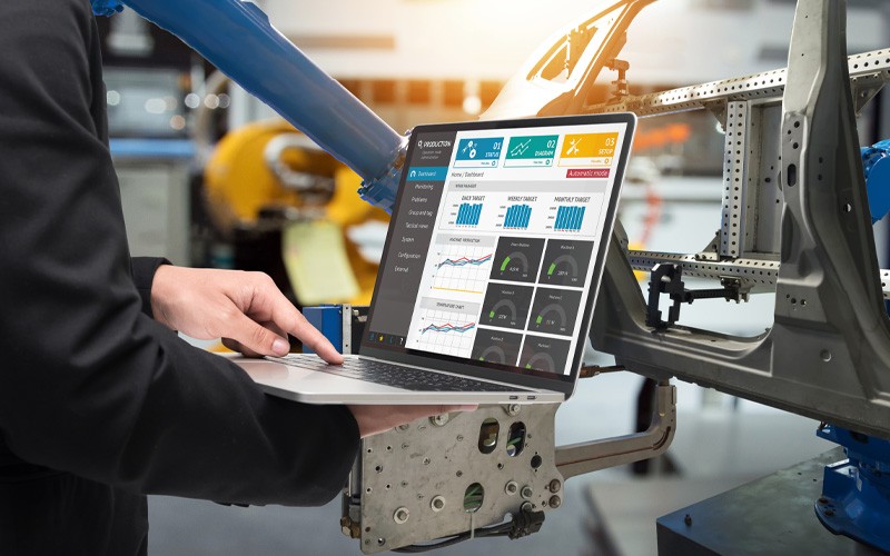 Support flawless coordination with the latest cloud and data center platforms Close up of laptop using manufacturing software to interact with machine