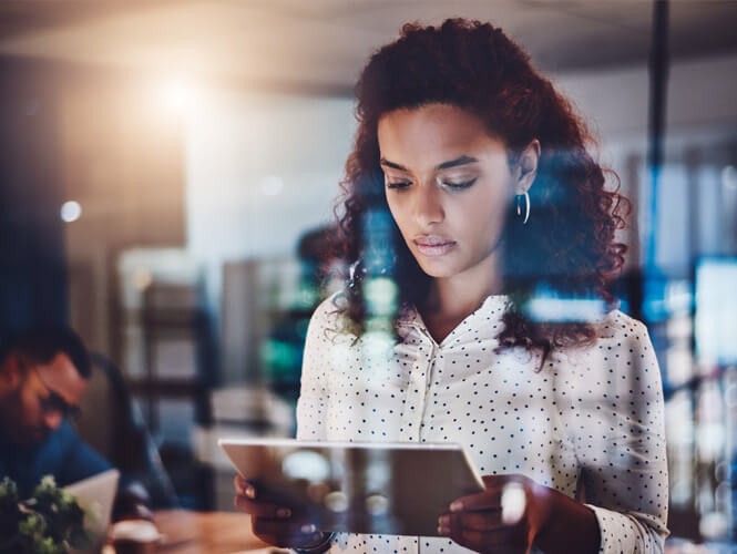 Offload your IT burden to our trusted team so you can focus on the road ahead Business professional using tablet computer