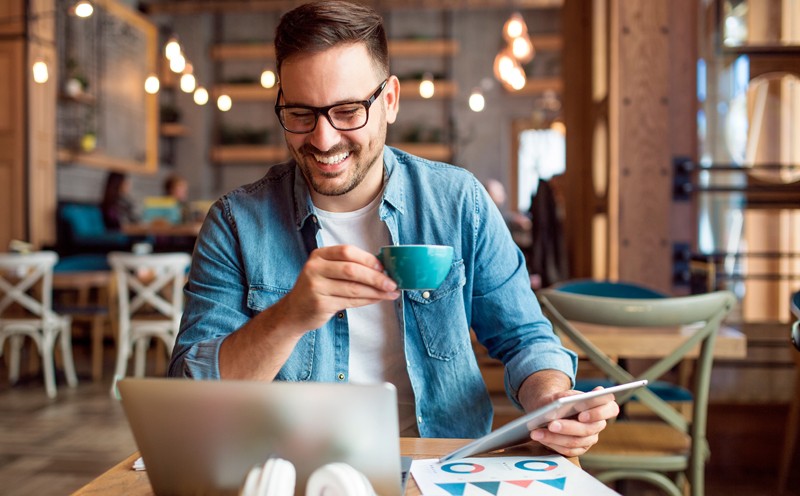 Manage your mobile workforce with ease. Two business colleagues use mobile tablet device