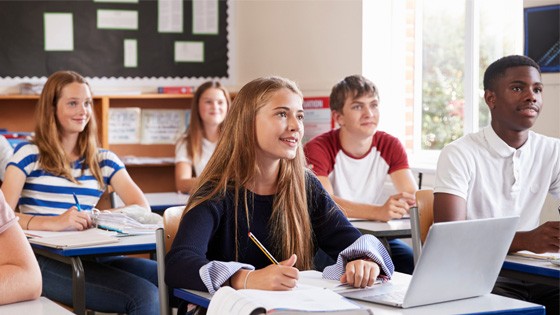 Students learning in Classroom Image of students watching presentation in class