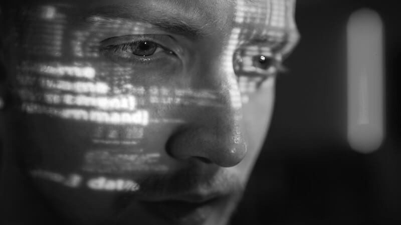 Business professional reading data off of computer monitor