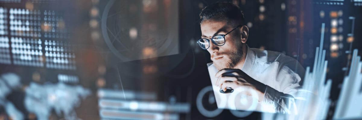 Male user on laptop late at night with graphics overlay