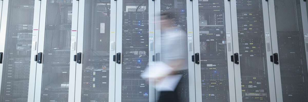 Engineers walking past sustainable and modern data storage systems