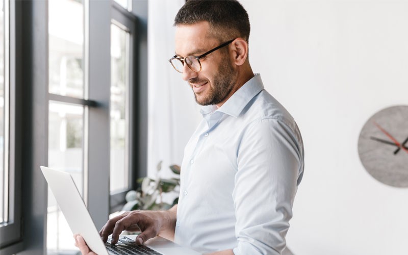 Businessman using laptop computer to view PDU report