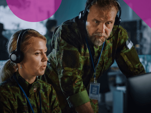 Two military engineers in facility looking at security insights