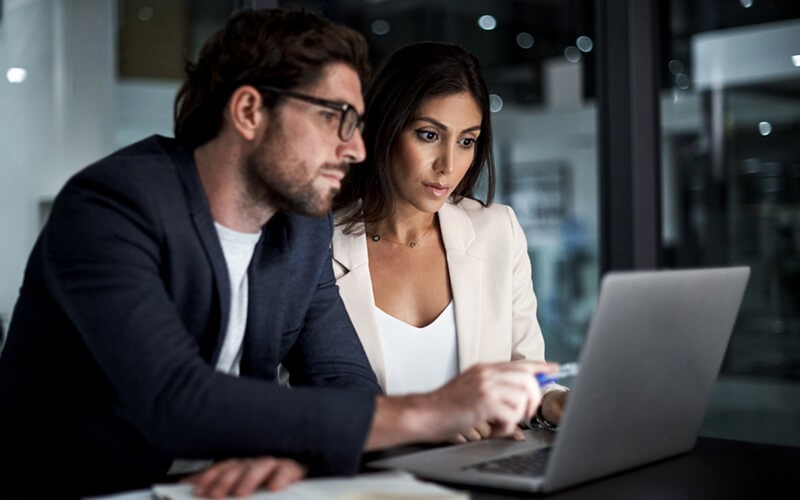 Business professional reading whitepaper off of tablet computer