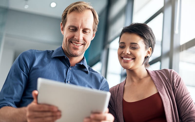 Business professional reading whitepaper off of tablet computer