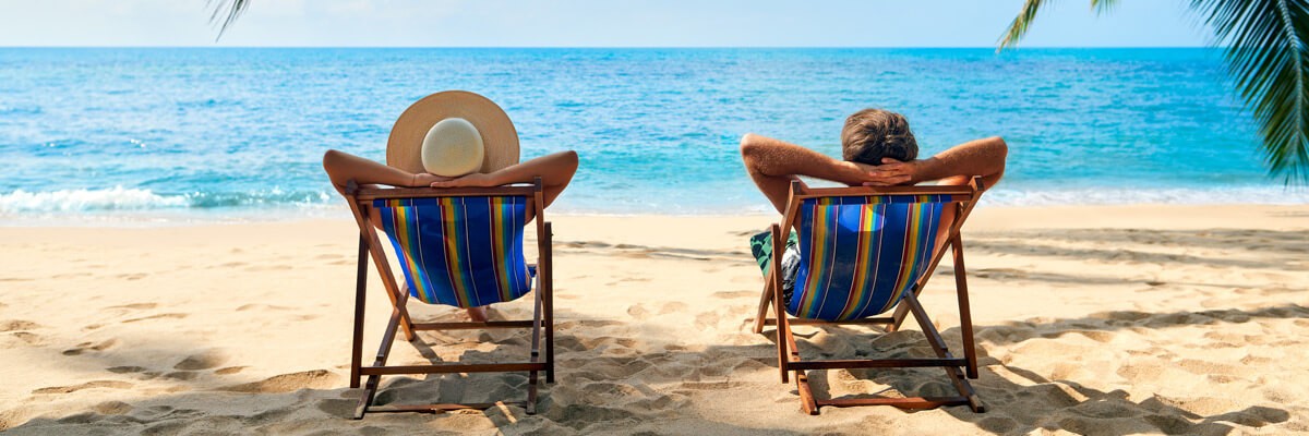 People relaxing on beach on vacation