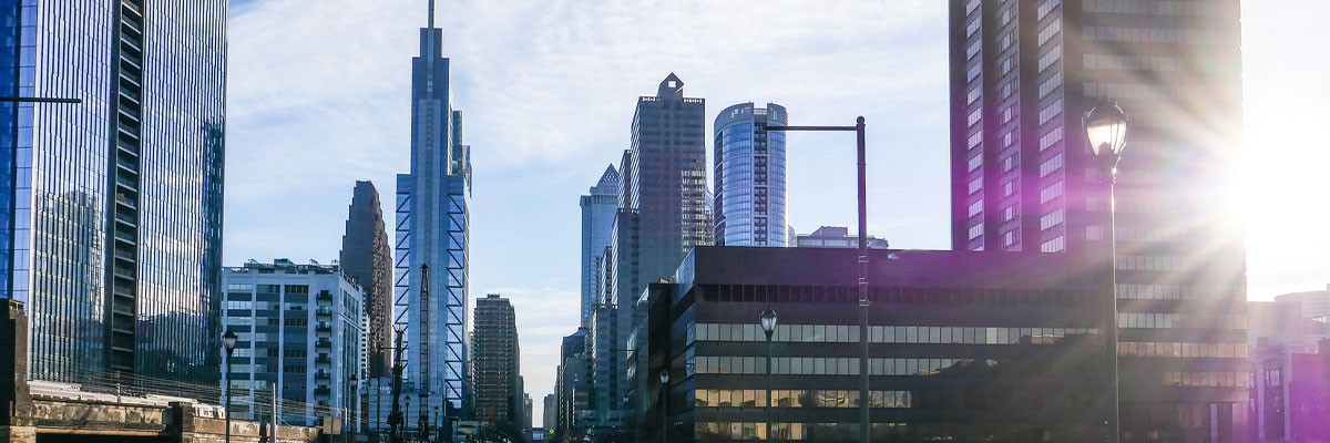 View of sunrise rising over skyscrapers in the city