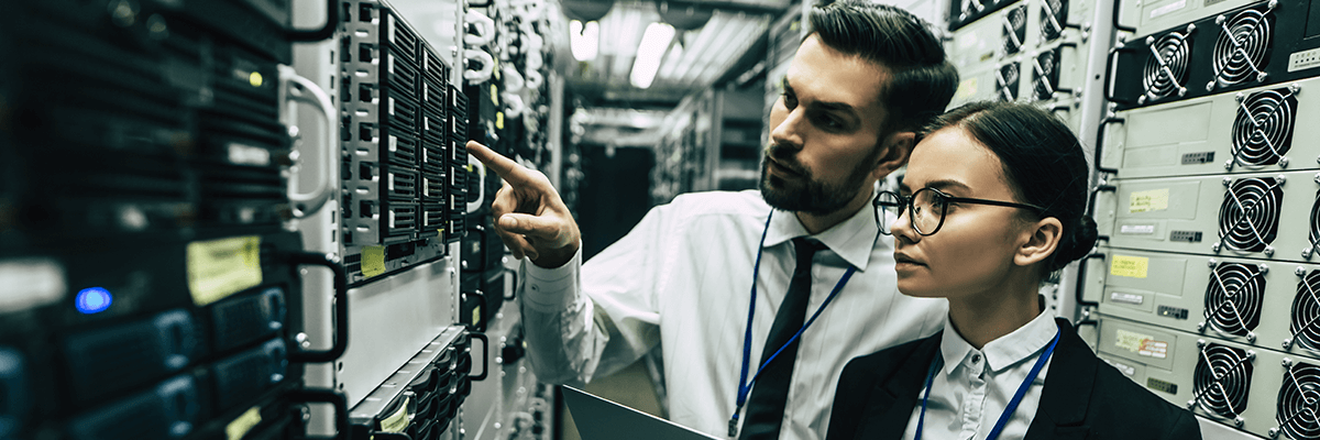 Two business people looking at a server