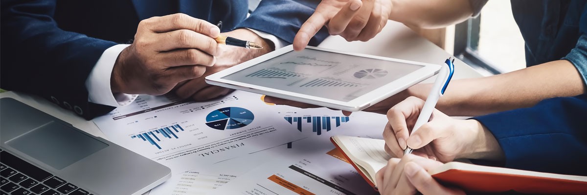 Close up view of financial analysts reviewing data