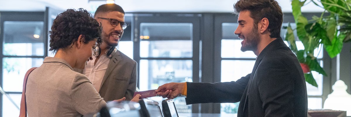 Hotel guests checking into a hotel. Supply chain optimization, device services, device management, provisioning, break-fix, refresh, support, customized procurement catalog