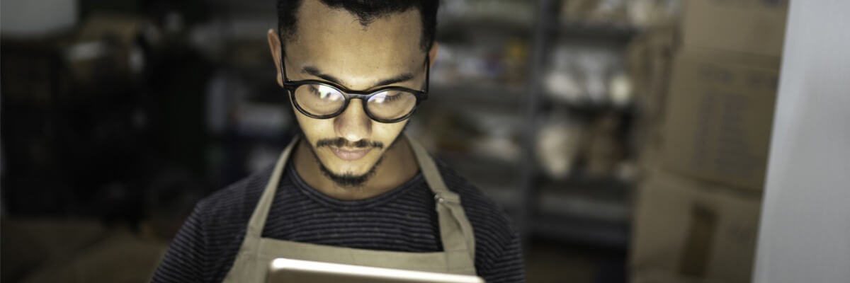 Retail employee using digital device