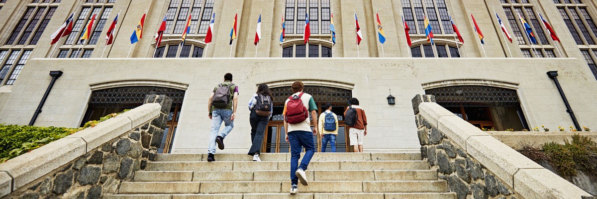 University students walking up the stairs to campus